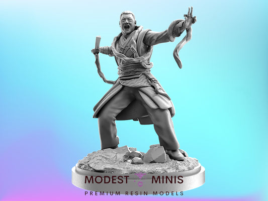 A statue of a man in a fighting stance, holding a weapon and appearing to be in a dramatic pose.