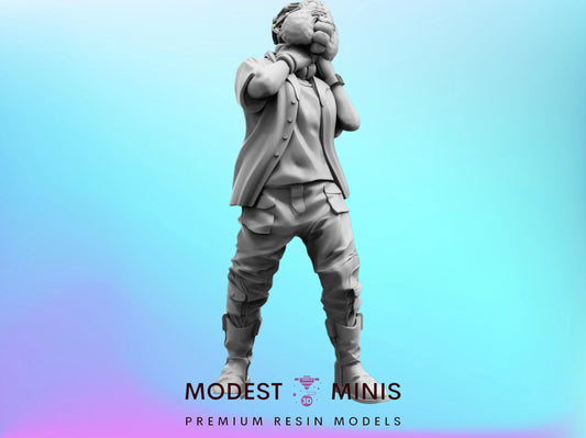 A statue of a person standing with their hands on their face, against a blue background.